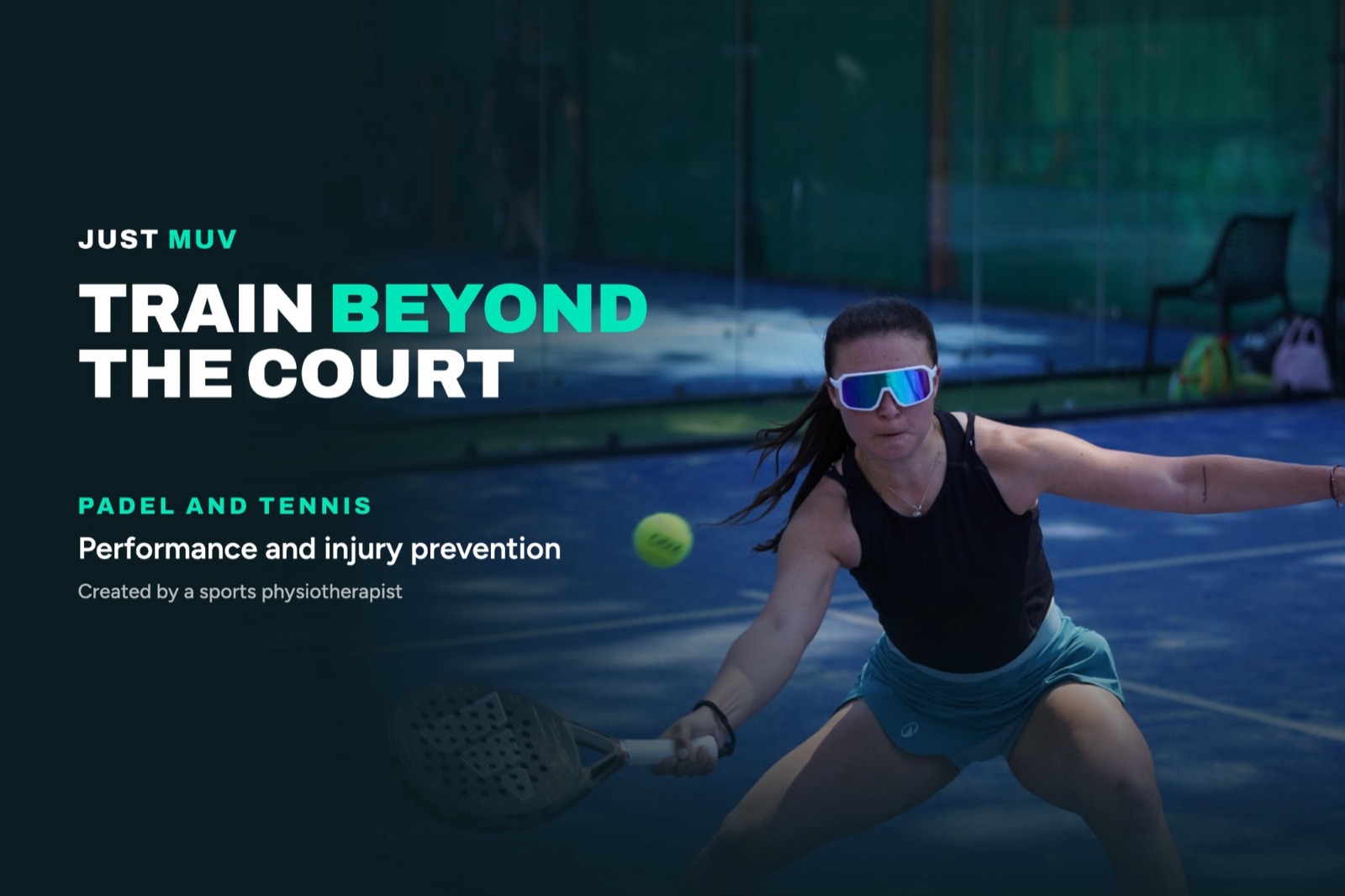 A padel player in sunglasses reaching low for a forehand on a blue court